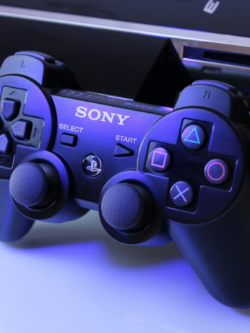 black Sony PS2 controller on white surface